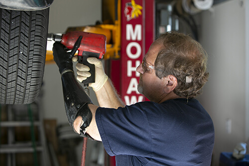 Gary, an amputee, is working on repairing a vehicle